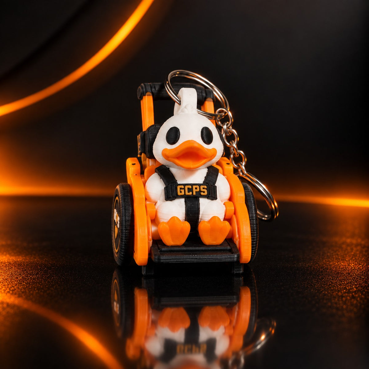 GCPS Mobility Duck keychain, front view, seated in its adaptive-chair form with the keyring attached