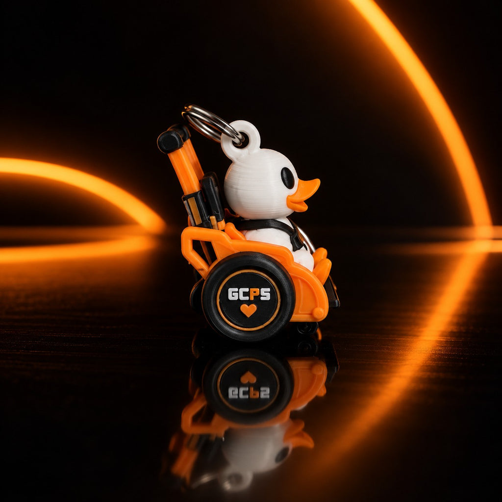 GCPS Mobility Duck keychain, side view, showing the GCPS wheel logo and heart detail
