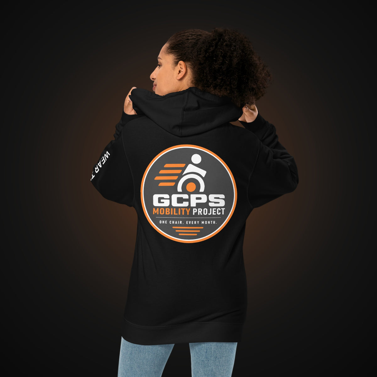 Person wearing the black GCPS Mobility Project Hoodie, back view showing the large GCPS Mobility Project badge