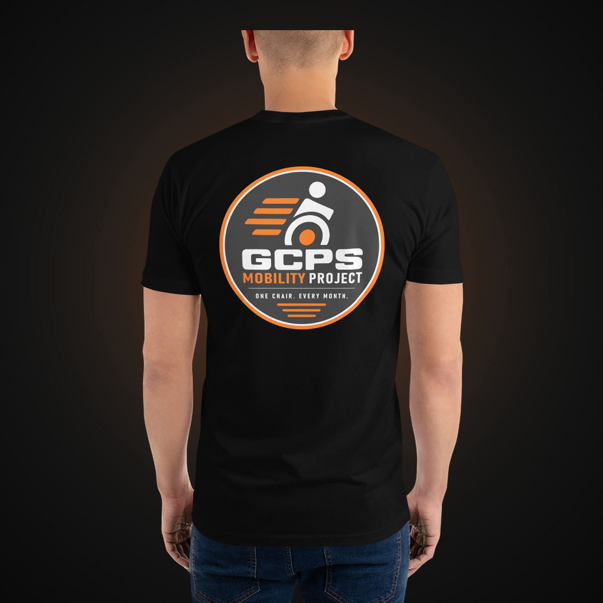 Person wearing the black GCPS Mobility Project T-Shirt, back view showing the large GCPS Mobility Project badge