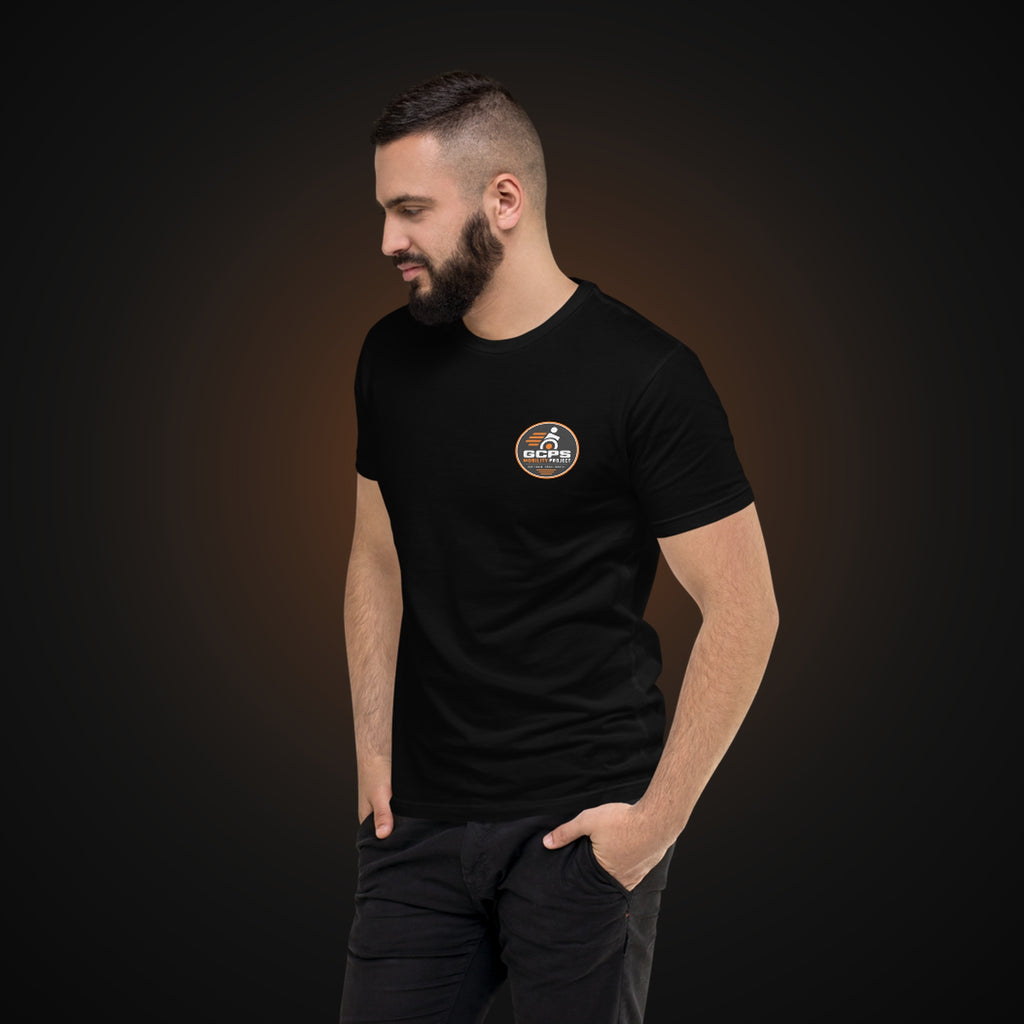 Person wearing the black GCPS Mobility Project T-Shirt, angled view showing the left chest badge